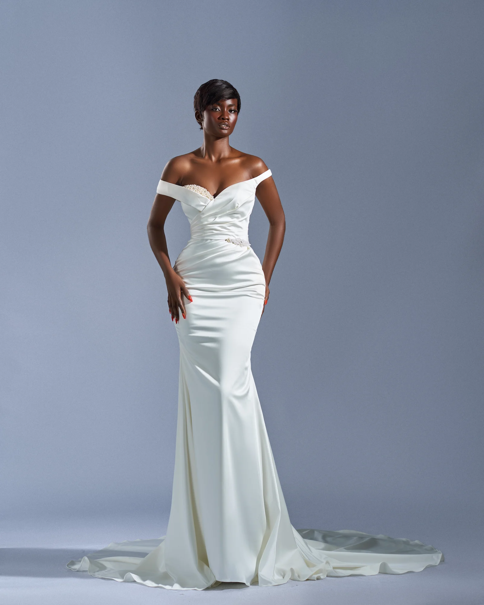 Asa satin bridal gown against a soft blue-gray studio background
