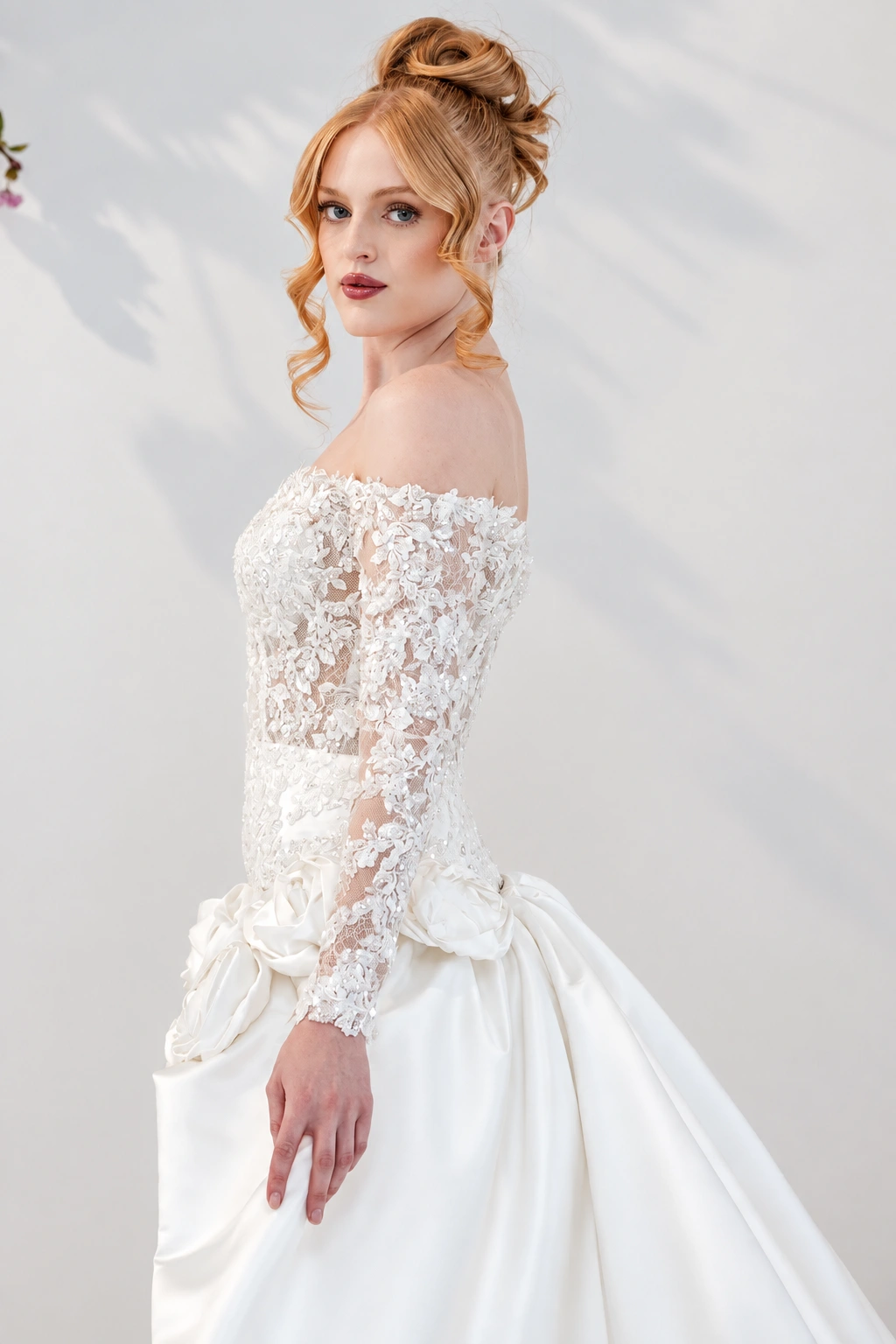 Bride in the Esther lace gown against a soft ivory backdrop
