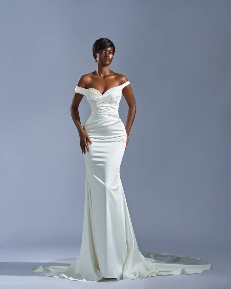 Asa satin bridal gown against a soft blue-gray studio background