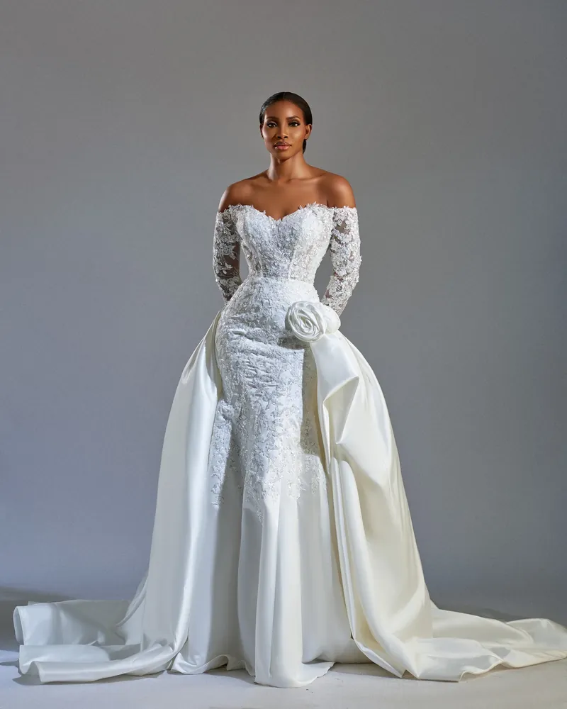 Esther lace bridal gown against a soft gray studio background
