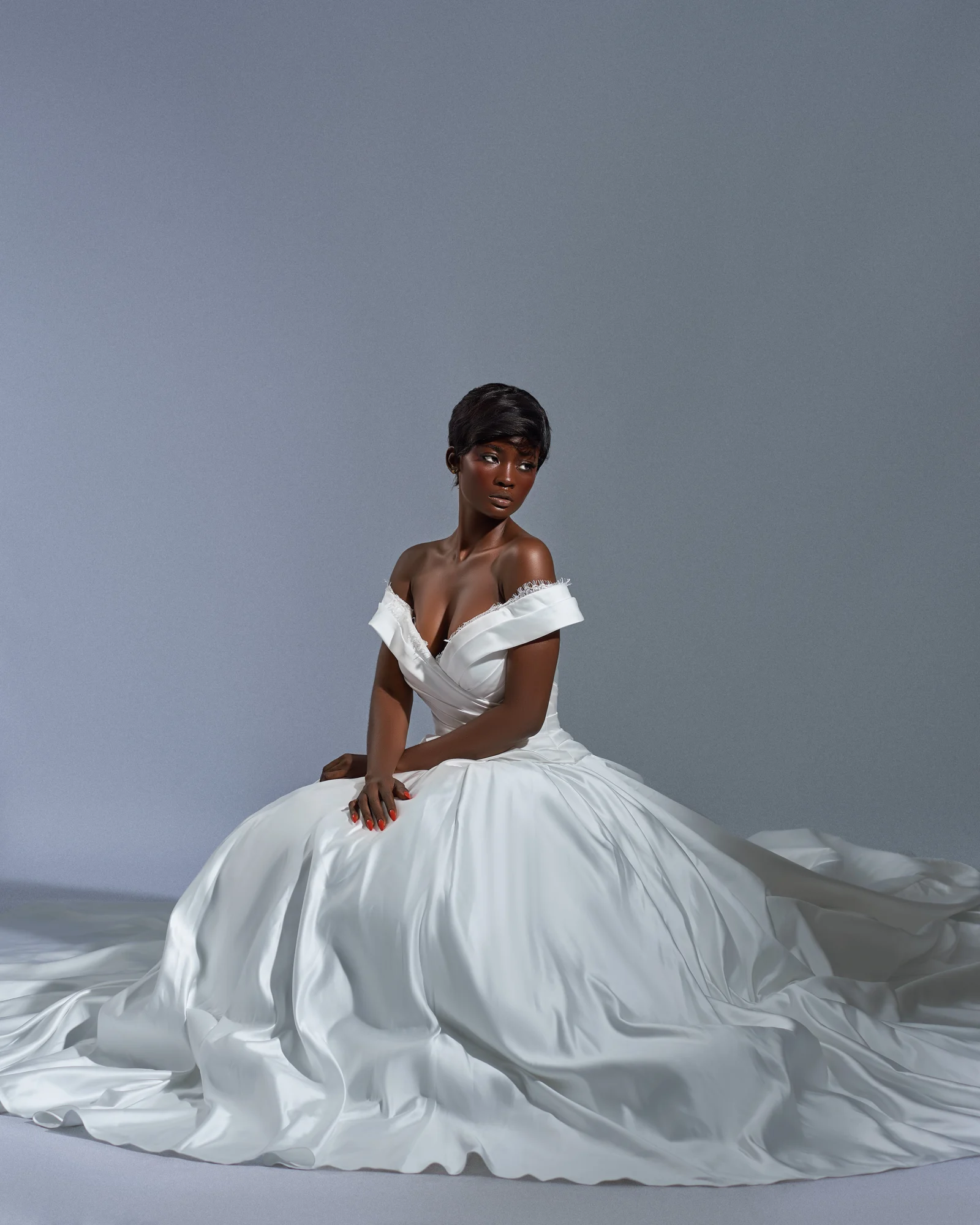 Selena satin gown in a seated editorial portrait